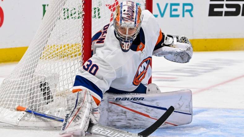 Mar 19, 2024; Elmont, New York, USA; New York Islanders goaltender Ilya Sorokin (30) makes a save against the Carolina Hurricanes during the third period at UBS Arena. Mandatory Credit: Dennis Schneidler-USA TODAY Sports