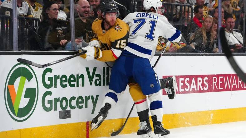 Mar 19, 2024; Las Vegas, Nevada, USA; Tampa Bay Lightning center Anthony Cirelli (71) checks Vegas Golden Knights defenseman Noah Hanifin (15) during the first period at T-Mobile Arena. Mandatory Credit: Stephen R. Sylvanie-USA TODAY Sports