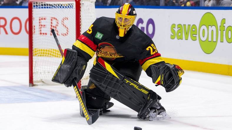 Mar 19, 2024; Vancouver, British Columbia, CAN; Vancouver Canucks goalie Casey DeSmith (29) handles the puck against the Buffalo Sabres in the second period at Rogers Arena. Mandatory Credit: Bob Frid-USA TODAY Sports