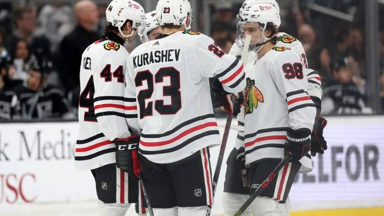 Mar 19, 2024; Los Angeles, California, USA;  Chicago Blackhawks defenseman Wyatt Kaiser (44) and center Philipp Kurashev (23) and center Connor Bedard (98) on the ice during the third period against the Los Angeles Kings at Crypto.com Arena. Mandatory Credit: Kiyoshi Mio-USA TODAY Sports