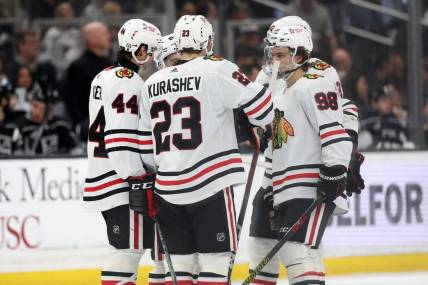 Mar 19, 2024; Los Angeles, California, USA;  Chicago Blackhawks defenseman Wyatt Kaiser (44) and center Philipp Kurashev (23) and center Connor Bedard (98) on the ice during the third period against the Los Angeles Kings at Crypto.com Arena. Mandatory Credit: Kiyoshi Mio-USA TODAY Sports