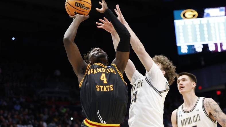 Mar 20, 2024; Dayton, OH, USA; Grambling State Tigers forward Antwan Burnett (4) goes to the basket defended by Montana State Bobcats guard Jed Miller (24) in the first half  at UD Arena. Mandatory Credit: Rick Osentoski-USA TODAY Sports