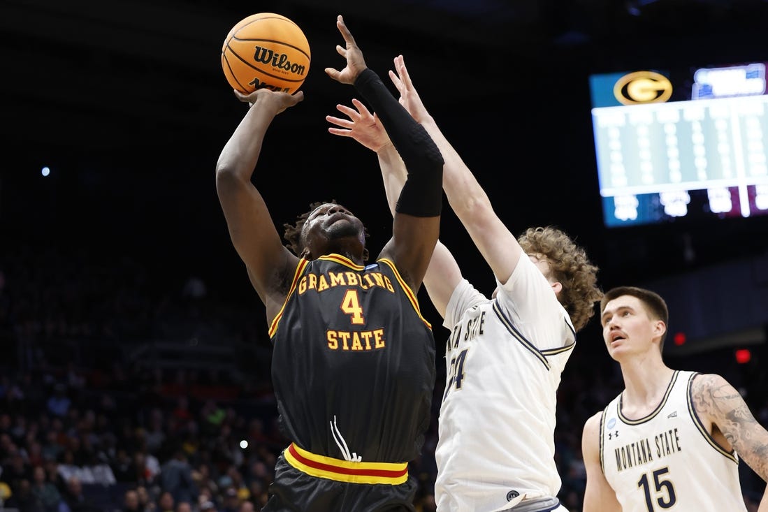 Mar 20, 2024; Dayton, OH, USA; Grambling State Tigers forward Antwan Burnett (4) goes to the basket defended by Montana State Bobcats guard Jed Miller (24) in the first half  at UD Arena. Mandatory Credit: Rick Osentoski-USA TODAY Sports