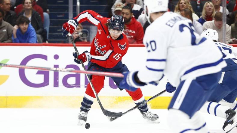 Mar 20, 2024; Washington, District of Columbia, USA; Washington Capitals left wing Sonny Milano (15) controls the puck in front of Toronto Maple Leafs defenseman Joel Edmundson (20) during the first period at Capital One Arena. Mandatory Credit: Amber Searls-USA TODAY Sports