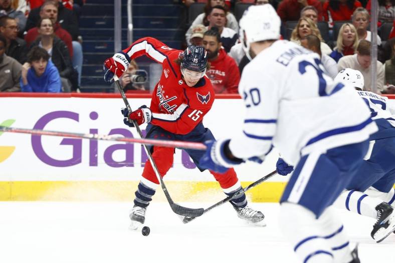 Mar 20, 2024; Washington, District of Columbia, USA; Washington Capitals left wing Sonny Milano (15) controls the puck in front of Toronto Maple Leafs defenseman Joel Edmundson (20) during the first period at Capital One Arena. Mandatory Credit: Amber Searls-USA TODAY Sports