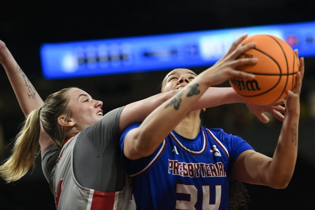 Bryanna Brady of Presbyterian is fouled going for a shot against Sacred Heart in the NCAA Women's Basketball Tournament in Columbia.