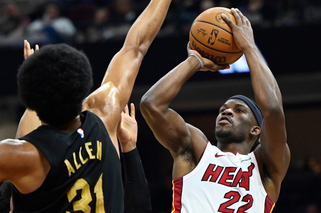 Mar 20, 2024; Cleveland, Ohio, USA; Miami Heat forward Jimmy Butler (22) shoots beside Cleveland Cavaliers center Jarrett Allen (31) in the second quarter at Rocket Mortgage FieldHouse. Mandatory Credit: David Richard-USA TODAY Sports