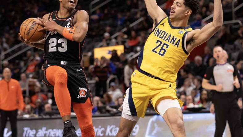 Mar 20, 2024; Detroit, Michigan, USA; Detroit Pistons guard Jaden Ivey (23) drives to the basket next to Indiana Pacers guard Ben Sheppard (26) in the first half at Little Caesars Arena. Mandatory Credit: David Reginek-USA TODAY Sports