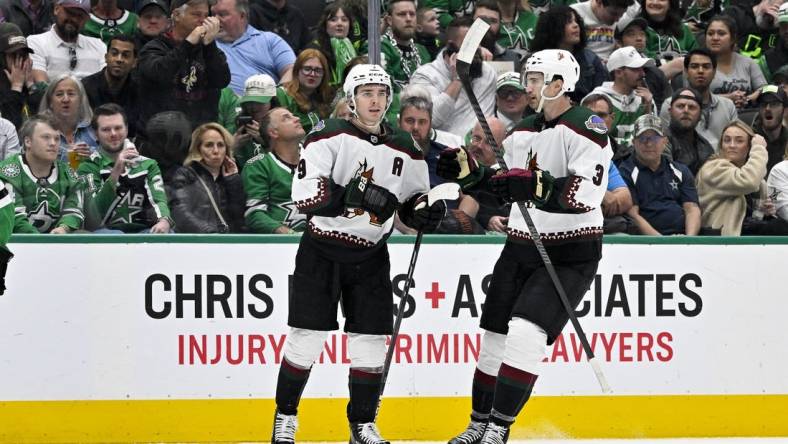 Mar 20, 2024; Dallas, Texas, USA; Arizona Coyotes right wing Clayton Keller (9) and defenseman Josh Brown (3) celebrates a goal scored by Keller against the Dallas Stars during the first period at the American Airlines Center. Mandatory Credit: Jerome Miron-USA TODAY Sports