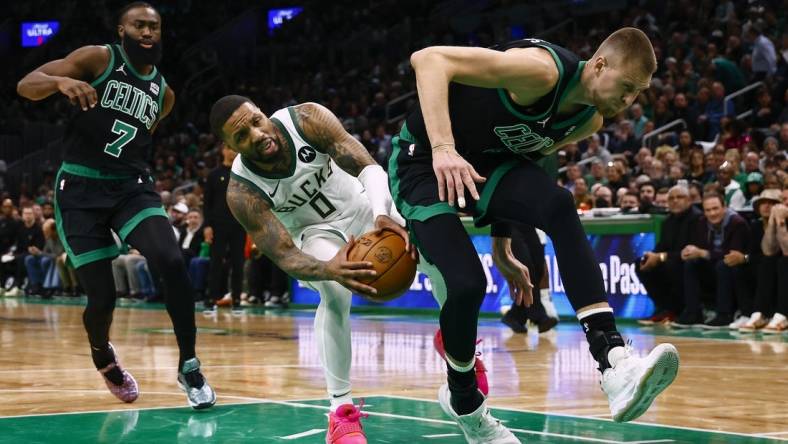 Mar 20, 2024; Boston, Massachusetts, USA; Milwaukee Bucks guard Damian Lillard (0) runs into the back of Boston Celtics center Kristaps Porzingis (8) during the second quarter at TD Garden. Mandatory Credit: Winslow Townson-USA TODAY Sports