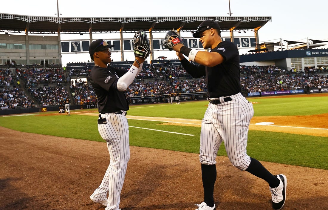 Mar 20, 2024; Tampa, Florida, USA; New York Yankees left fielder Juan Soto (22) and right fielder Aaron Judge (99) high five against the Pittsburgh Pirates at George M. Steinbrenner Field. Mandatory Credit: Kim Klement Neitzel-USA TODAY Sports