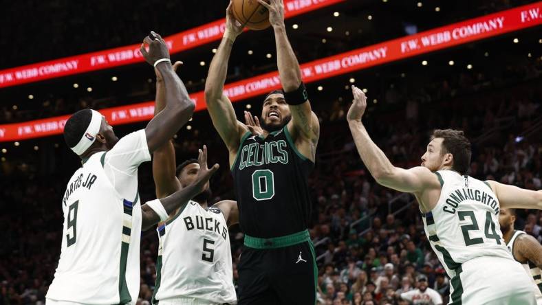 Mar 20, 2024; Boston, Massachusetts, USA; Boston Celtics forward Jayson Tatum (0) goes to the basket between Milwaukee Bucks guard Pat Connaughton (24) and forward Bobby Portis (9) during the second half at TD Garden. Mandatory Credit: Winslow Townson-USA TODAY Sports