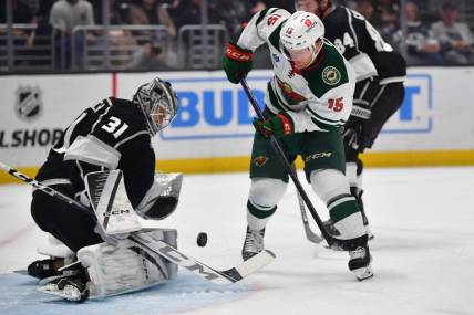 Mar 20, 2024; Los Angeles, California, USA; Los Angeles Kings goaltender David Rittich (31) blocks a shot against Minnesota Wild center Mason Shaw (15) during the first period at Crypto.com Arena. Mandatory Credit: Gary A. Vasquez-USA TODAY Sports