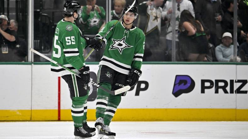 Mar 20, 2024; Dallas, Texas, USA; Dallas Stars defenseman Thomas Harley (55) and left wing Jason Robertson (21) celebrates a goal scored by Robertson against the Arizona Coyotes during the third period at the American Airlines Center. Mandatory Credit: Jerome Miron-USA TODAY Sports