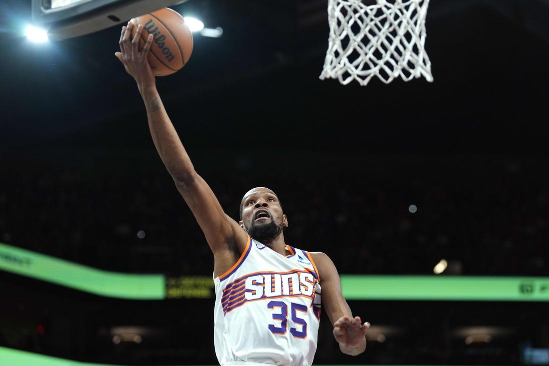 Mar 20, 2024; Phoenix, Arizona, USA; Phoenix Suns forward Kevin Durant (35) makes a layup against the Philadelphia 76ers during the first half at Footprint Center. Mandatory Credit: Joe Camporeale-USA TODAY Sports