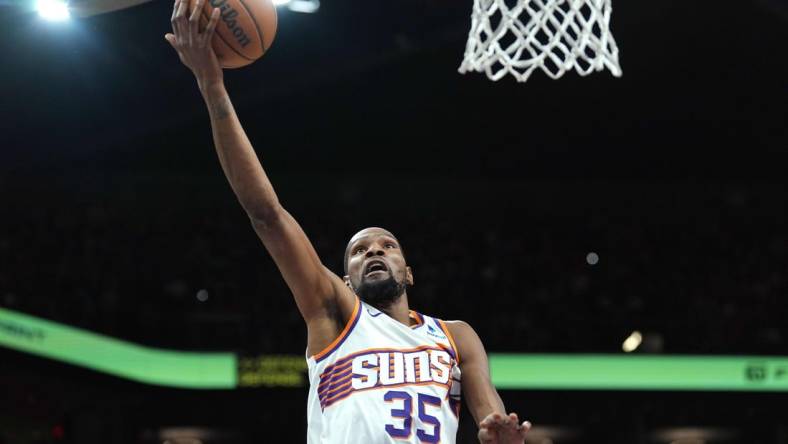 Mar 20, 2024; Phoenix, Arizona, USA; Phoenix Suns forward Kevin Durant (35) makes a layup against the Philadelphia 76ers during the first half at Footprint Center. Mandatory Credit: Joe Camporeale-USA TODAY Sports