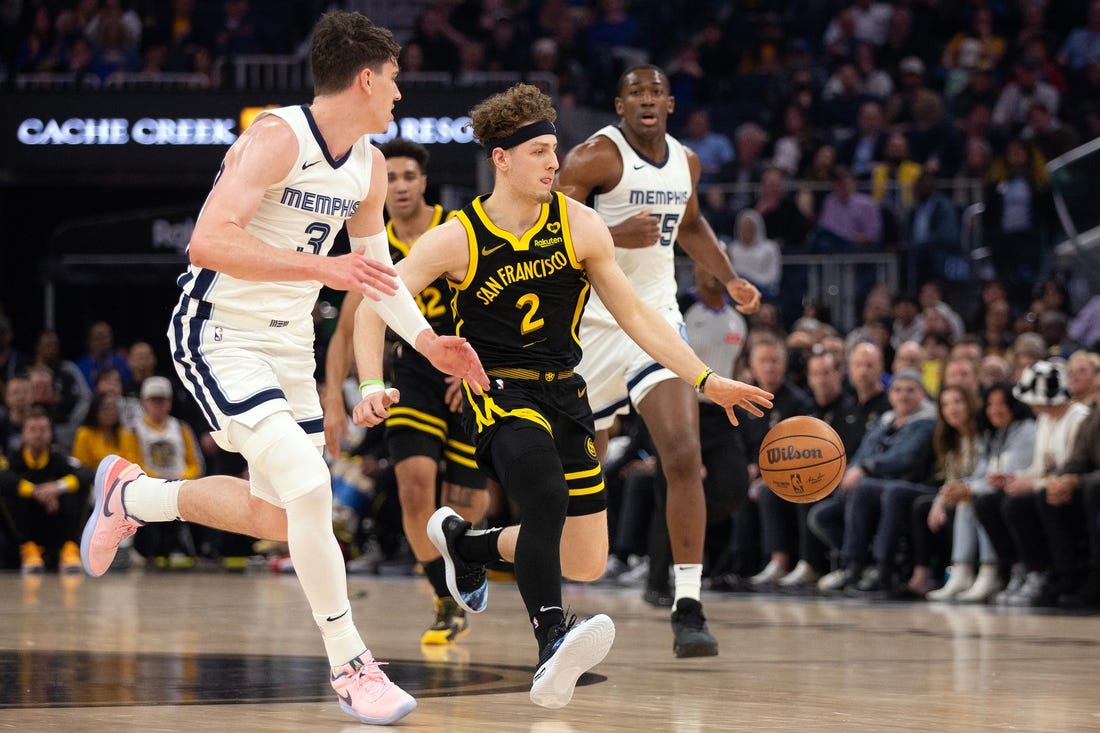 Mar 20, 2024; San Francisco, California, USA; Golden State Warriors guard Brandin Podziemski (2) drives between Memphis Grizzlies forward Jake LaRavia (3) and center Trey Jemison (55) during the first quarter at Chase Center. Mandatory Credit: D. Ross Cameron-USA TODAY Sports