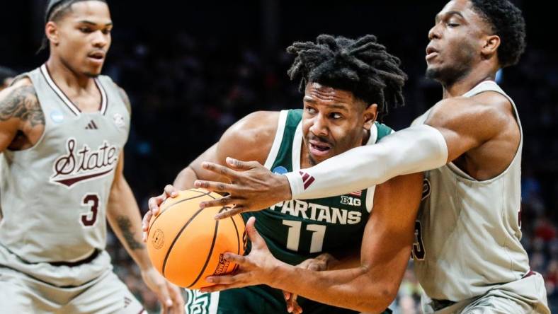 Michigan State guard A.J. Hoggard (11) looks to pass against Mississippi State guard Josh Hubbard (13) during the first half of NCAA tournament West Region first round at Spectrum Center in Charlotte, N.C. on Thursday, March 21, 2024.