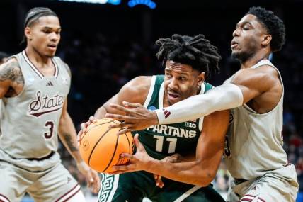 Michigan State guard A.J. Hoggard (11) looks to pass against Mississippi State guard Josh Hubbard (13) during the first half of NCAA tournament West Region first round at Spectrum Center in Charlotte, N.C. on Thursday, March 21, 2024.