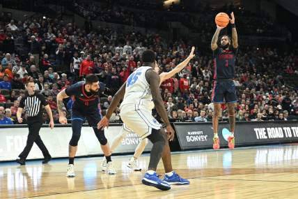 Mar 21, 2024; Omaha, NE, USA;  Duquesne Dukes guard Dae Dae Grant (3) shoots during the first half against the Brigham Young Cougars during the first round of the NCAA Tournament at CHI Health Center Omaha. Mandatory Credit: Steven Branscombe-USA TODAY Sports