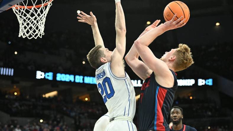 Mar 21, 2024; Omaha, NE, USA; Duquesne Dukes forward Jakub Necas (7) shoots against Brigham Young Cougars guard Spencer Johnson (20) in the first half during the first round of the NCAA Tournament at CHI Health Center Omaha. Mandatory Credit: Steven Branscombe-USA TODAY Sports