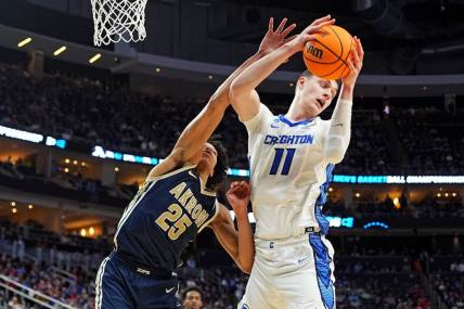 Mar 21, 2024; Pittsburgh, PA, USA; Creighton Bluejays center Ryan Kalkbrenner (11) grabs a rebound against Akron Zips forward Enrique Freeman (25) during the second half in the first round of the 2024 NCAA Tournament at PPG Paints Arena. Mandatory Credit: Gregory Fisher-USA TODAY Sports