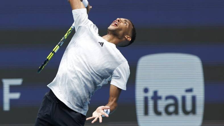 Mar 21, 2024; Miami Gardens, FL, USA; Felix Auger-Aliassime (CAN) serves against Adam Walton (AUS)(not pictured) on day four of the Miami Open at Hard Rock Stadium. Mandatory Credit: Geoff Burke-USA TODAY Sports