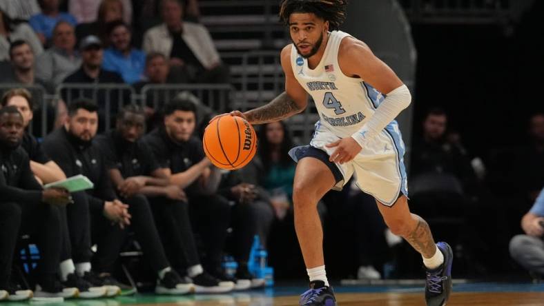 March 21, 2024, Charlotte, NC, USA; North Carolina Tar Heels guard RJ Davis (4) controls the ball against the Wagner Seahawks in the first round of the 2024 NCAA Tournament at the Spectrum Center. Mandatory Credit: Jim Dedmon-USA TODAY Sports