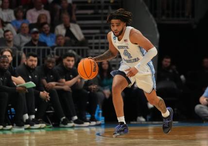 March 21, 2024, Charlotte, NC, USA; North Carolina Tar Heels guard RJ Davis (4) controls the ball against the Wagner Seahawks in the first round of the 2024 NCAA Tournament at the Spectrum Center. Mandatory Credit: Jim Dedmon-USA TODAY Sports