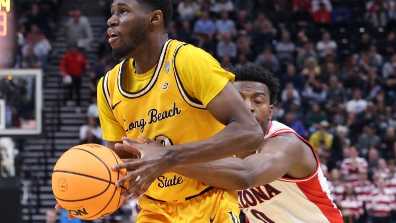 Mar 21, 2024; Salt Lake City, UT, USA; Long Beach State 49ers guard Jadon Jones (12) defended by Arizona Wildcats guard Jaden Bradley (0) during the second half in the first round of the 2024 NCAA Tournament at Vivint Smart Home Arena-Delta Center. Mandatory Credit: Rob Gray-USA TODAY Sports