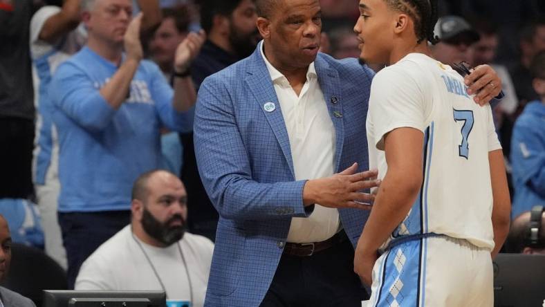 March 21, 2024, Charlotte, NC, USA;  North Carolina Tar Heels head coach Hubert Davis talks with guard Seth Trimble (7) as they play against the Wagner Seahawks in the first round of the 2024 NCAA Tournament at the Spectrum Center. Mandatory Credit: Jim Dedmon-USA TODAY Sports