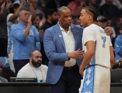 March 21, 2024, Charlotte, NC, USA;  North Carolina Tar Heels head coach Hubert Davis talks with guard Seth Trimble (7) as they play against the Wagner Seahawks in the first round of the 2024 NCAA Tournament at the Spectrum Center. Mandatory Credit: Jim Dedmon-USA TODAY Sports