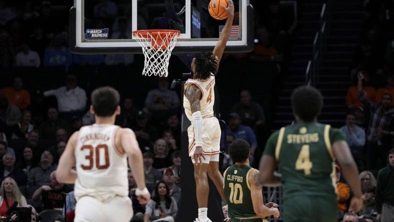 Mar 21, 2024; Charlotte, NC, USA; Texas Longhorns guard Tyrese Hunter (4) puts up a layup in the first half of the first round of the 2024 NCAA Tournament at Spectrum Center. Mandatory Credit: Bob Donnan-USA TODAY Sports