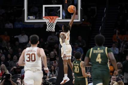 Mar 21, 2024; Charlotte, NC, USA; Texas Longhorns guard Tyrese Hunter (4) puts up a layup in the first half of the first round of the 2024 NCAA Tournament at Spectrum Center. Mandatory Credit: Bob Donnan-USA TODAY Sports