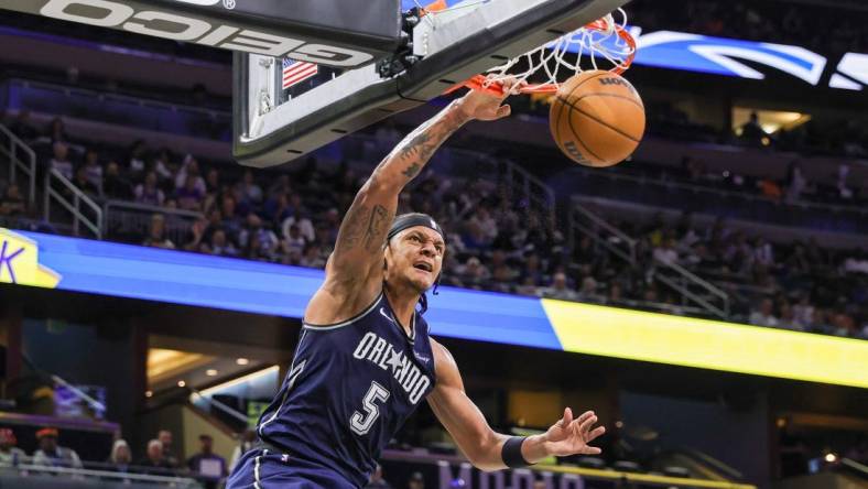 Mar 21, 2024; Orlando, Florida, USA; Orlando Magic forward Paolo Banchero (5) dunks during the second quarter against the New Orleans Pelicans at KIA Center. Mandatory Credit: Mike Watters-USA TODAY Sports