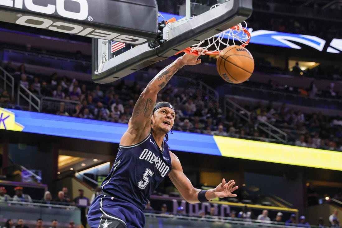 Mar 21, 2024; Orlando, Florida, USA; Orlando Magic forward Paolo Banchero (5) dunks during the second quarter against the New Orleans Pelicans at KIA Center. Mandatory Credit: Mike Watters-USA TODAY Sports