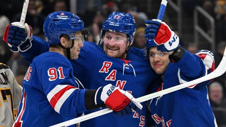 Mar 21, 2024; Boston, Massachusetts, USA; New York Rangers left wing Artemi Panarin (10) celebrates with left wing Alexis Lafreniere (13) and center Alex Wennberg (91) after scoring a goal against the Boston Bruins during the second period at the TD Garden. Mandatory Credit: Brian Fluharty-USA TODAY Sports