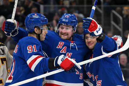 Mar 21, 2024; Boston, Massachusetts, USA; New York Rangers left wing Artemi Panarin (10) celebrates with left wing Alexis Lafreniere (13) and center Alex Wennberg (91) after scoring a goal against the Boston Bruins during the second period at the TD Garden. Mandatory Credit: Brian Fluharty-USA TODAY Sports
