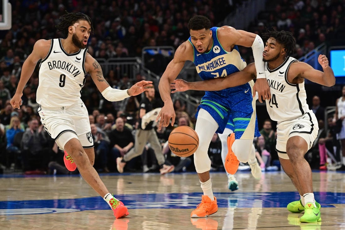 Mar 21, 2024; Milwaukee, Wisconsin, USA; Milwaukee Bucks forward Giannis Antetokounmpo (34) drives for the basket between Brooklyn Nets forward Trendon Watford (9) and guard Cameron Thomas (24) in the second quarter at Fiserv Forum. Mandatory Credit: Benny Sieu-USA TODAY Sports