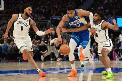 Mar 21, 2024; Milwaukee, Wisconsin, USA; Milwaukee Bucks forward Giannis Antetokounmpo (34) drives for the basket between Brooklyn Nets forward Trendon Watford (9) and guard Cameron Thomas (24) in the second quarter at Fiserv Forum. Mandatory Credit: Benny Sieu-USA TODAY Sports