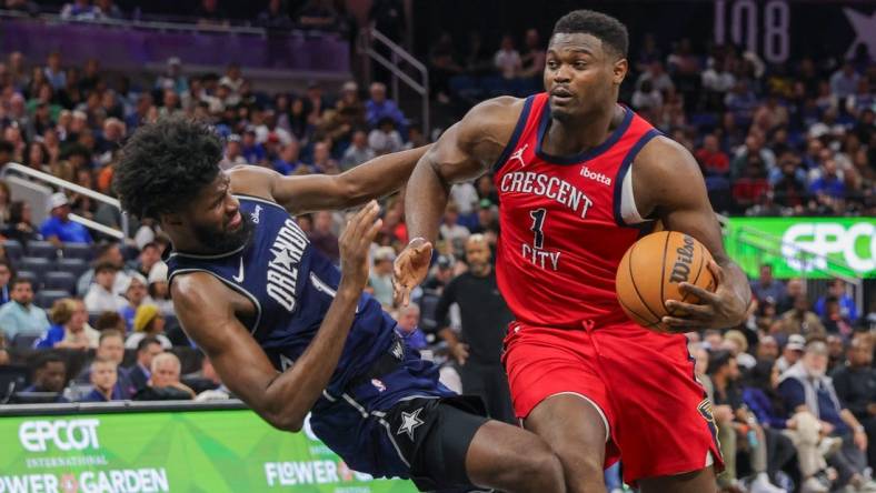 Mar 21, 2024; Orlando, Florida, USA; New Orleans Pelicans forward Zion Williamson (1) is fouled by Orlando Magic forward Jonathan Isaac (1) during the second half at KIA Center. Mandatory Credit: Mike Watters-USA TODAY Sports