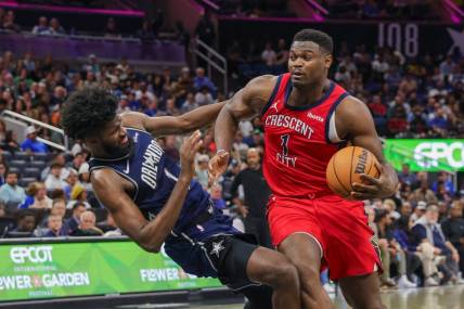 Mar 21, 2024; Orlando, Florida, USA; New Orleans Pelicans forward Zion Williamson (1) is fouled by Orlando Magic forward Jonathan Isaac (1) during the second half at KIA Center. Mandatory Credit: Mike Watters-USA TODAY Sports