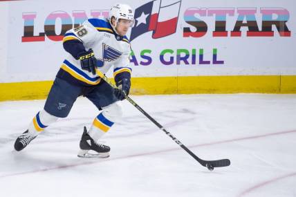 Mar 21, 2024; Ottawa, Ontario, CAN; St. Louis Blues defenseman Scott Perunovich (48) skates with the puck in the third period against the Ottawa Senators at the Canadian Tire Centre. Mandatory Credit: Marc DesRosiers-USA TODAY Sports