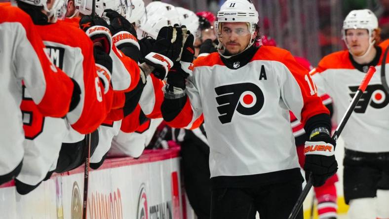 Mar 21, 2024; Raleigh, North Carolina, USA; Philadelphia Flyers right wing Travis Konecny (11) celebrates his goal against the Carolina Hurricanes during the third period at PNC Arena. Mandatory Credit: James Guillory-USA TODAY Sports