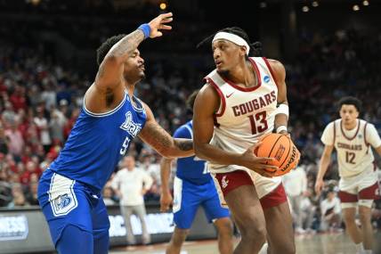 Mar 21, 2024; Omaha, NE, USA; Washington State Cougars guard Isaiah Watts (12) controls the ball against Drake Bulldogs forward Darnell Brodie (51) in the first half in the first round of the 2024 NCAA Tournament at CHI Health Center Omaha. Mandatory Credit: Steven Branscombe-USA TODAY Sports