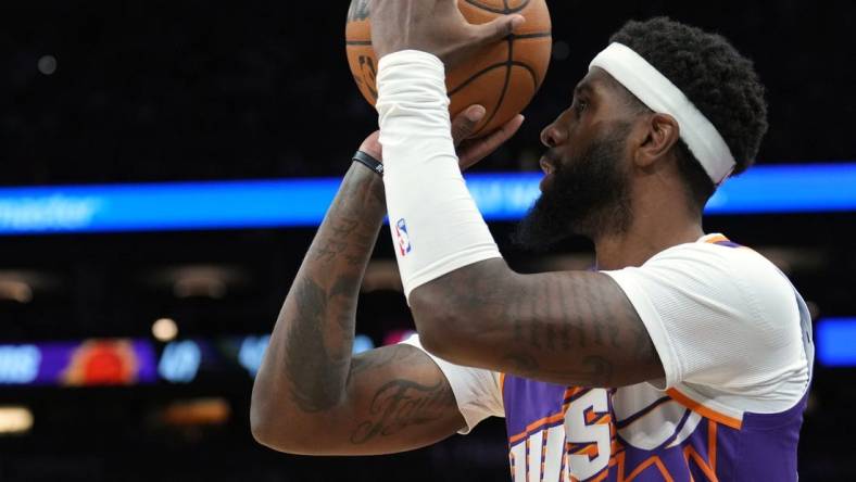 Mar 21, 2024; Phoenix, Arizona, USA; Phoenix Suns forward Royce O'Neale (00) shoots against the Atlanta Hawks during the first half at Footprint Center. Mandatory Credit: Joe Camporeale-USA TODAY Sports