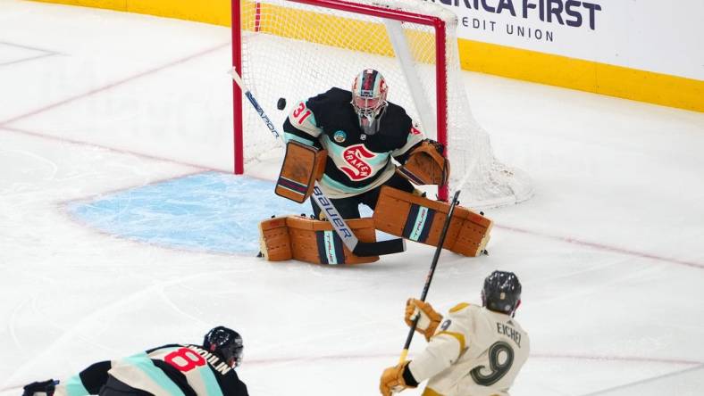 Mar 21, 2024; Las Vegas, Nevada, USA; Seattle Kraken goaltender Philipp Grubauer (31) defends his net against a shot from Vegas Golden Knights center Jack Eichel (9) during the first period at T-Mobile Arena. Mandatory Credit: Stephen R. Sylvanie-USA TODAY Sports