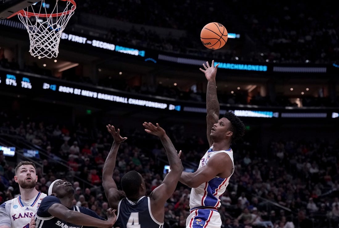 Mar 21, 2024; Salt Lake City, UT, USA; Kansas Jayhawks forward K.J. Adams Jr. (24) shoots against Samford Bulldogs forward Jermaine Marshall (4) during the second half in the first round of the 2024 NCAA Tournament at Vivint Smart Home Arena-Delta Center. Mandatory Credit: Gabriel Mayberry-USA TODAY Sports