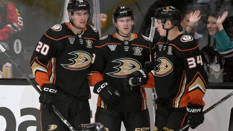 Mar 21, 2024; Anaheim, California, USA;  Anaheim Ducks right wing Brett Leason (20) is congratulated by center Ben Meyers (39) and defenseman Pavel Mintyukov (34) after scoring a goal in the second period against the Chicago Blackhawks at Honda Center. Mandatory Credit: Jayne Kamin-Oncea-USA TODAY Sports