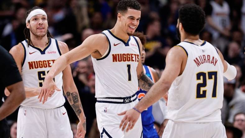 Mar 21, 2024; Denver, Colorado, USA; Denver Nuggets forward Michael Porter Jr. (1) reacts with guard Jamal Murray (27) ahead of forward Aaron Gordon (50) in the fourth quarter against the New York Knicks at Ball Arena. Mandatory Credit: Isaiah J. Downing-USA TODAY Sports